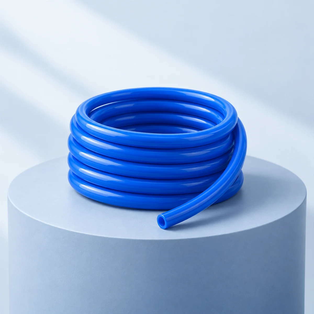 Conceptual illustration of a single blue pneumatic tubing coil on a pale-blue plinth